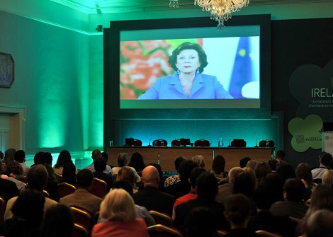 Delegates in St. George’s Hall, Dublin Castle, watching a video address from Mrs. Neelie Kroes, Vice-President of the European Commission